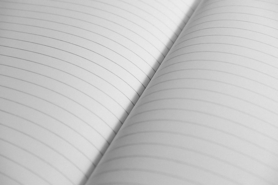 High-resolution close-up of an open notebook with lined pages, perfect for stationery concepts.